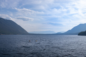 Kayakers on Lake McDonald at Glacier National Park with View of mountain range