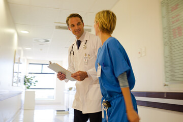 Obraz premium Nurse and doctor walking in hospital hallway