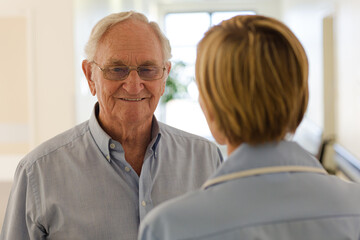 Nurse talking with older patient in hospital