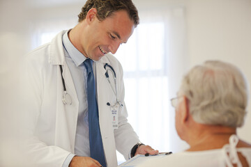 Fototapeta premium Doctor talking to older patient in hospital