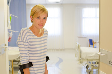 Patient using crutches in hospital room