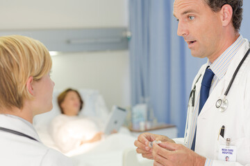 Obraz premium Doctor checking syringe in hospital room