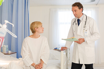 Obraz premium Doctor talking with patient in hospital room