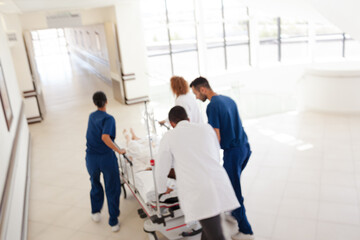 Hospital staff rushing patient to hospital room