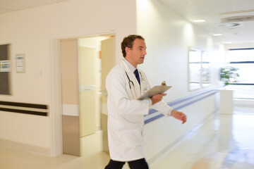 Naklejka na ściany i meble Doctor rushing in hospital hallway