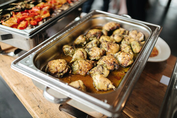 Cooked chicken in a silver tray at a buffet
