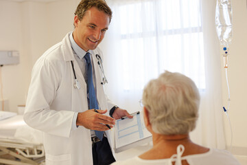 Fototapeta premium Doctor talking with patient in hospital room