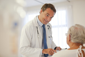 Fototapeta na wymiar Doctor talking to older patient in hospital