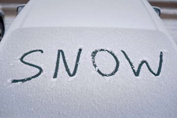 Snow on rear car glass. Winter car season concept, glass covered with snow. Difficult weather for drivers and transport. First snow on car window, winter background