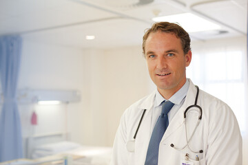 Doctor smiling in hospital hallway