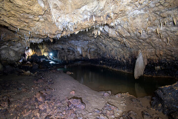 Fototapeta premium The dark cave is refracted by the flashlight