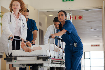 Hospital staff rushing patient to hospital room