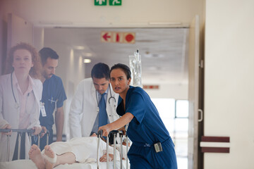 Hospital staff rushing patient to hospital room