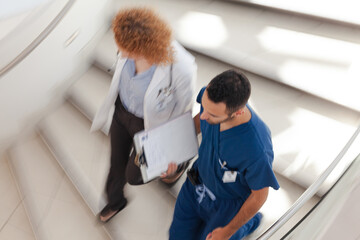 Doctor and nurse walking on hospital steps