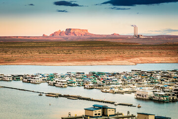 Houseboats on Glen Canyon and Powell Lake at sunset hours near the City of Page, Arizona, USA.