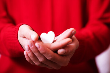 Obraz na płótnie Canvas White heart. Woman hand holding heart. Background. Sensual. Finger. 