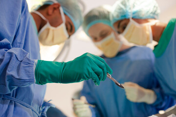 Surgeons bent over patient on operating table
