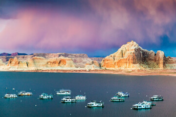 Fototapeta premium Houseboats on Glen Canyon and Powell Lake at sunset hours near the City of Page, Arizona, USA.