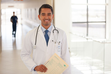 Doctor smiling in hospital hallway