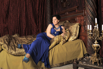 lady in blue dress on the bed in vintage interior