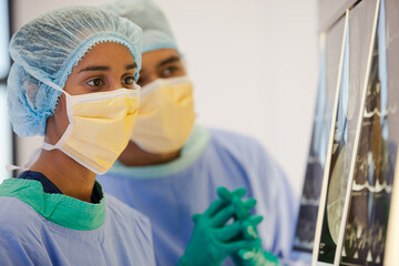 Surgeons examining x-rays in hospital