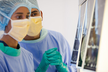 Surgeons examining x-rays in hospital