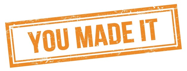 YOU MADE IT text on orange grungy vintage stamp.