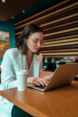 woman working on laptop in cafe