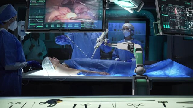 Team of professional surgeons perform a delicate operation using medical surgical robot while observing data on transparent screens. Modern medical equipment. Robotic arm for minimal invasive surgery.