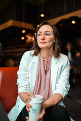 woman drinking coffee in a coffee shop