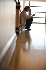 Doctor using cell phone in hospital hallway