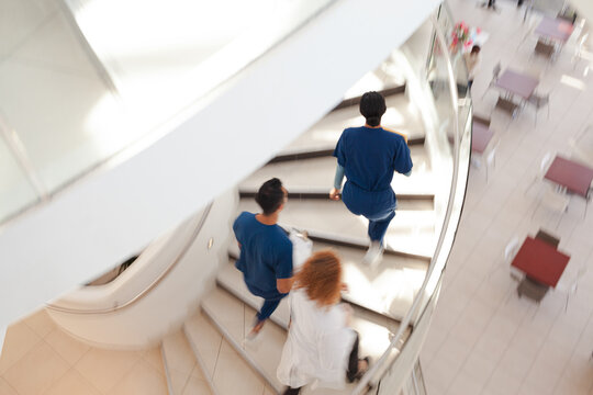 Hospital staff climbing spiral steps