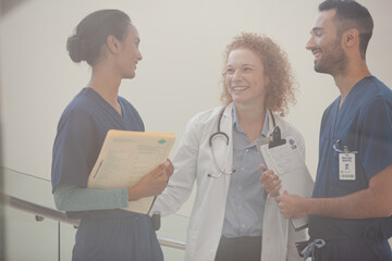 Hospital staff talking near staircase