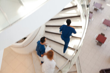Obraz premium Hospital staff climbing spiral steps
