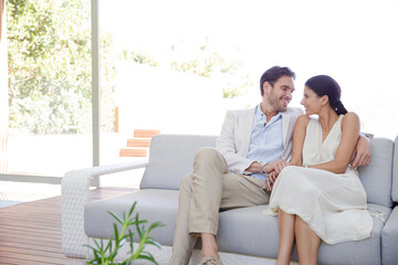 Portrait of smiling couple on sofa