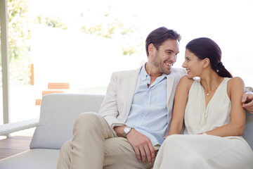 Portrait of smiling couple on sofa