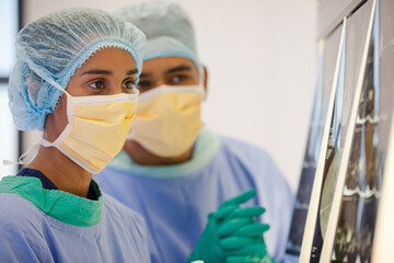 Fototapeta na wymiar Surgeons examining x-rays in hospital