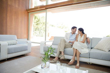Portrait of smiling couple on sofa