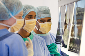 Surgeons examining x-rays in operating room