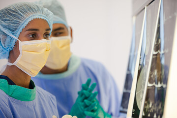 Surgeons examining x-rays in hospital