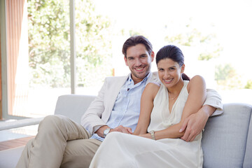 Portrait of smiling couple on sofa