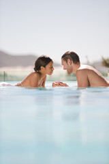 Couple relaxing together in swimming pool