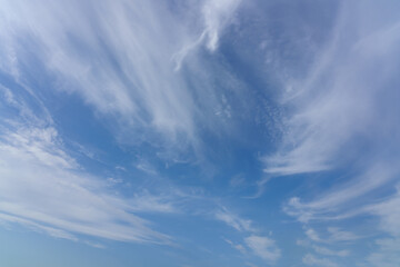 Blue sky with beautiful wispy clouds. Abstract sky background.