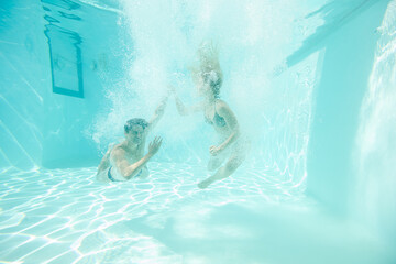 Couple touching hands underwater