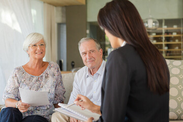 Financial advisor talking to couple on sofa