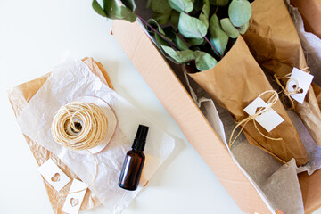 Mailbox with green eucalyptus leaves in. White background. Flat lay, top view. Flower Shop Concept.