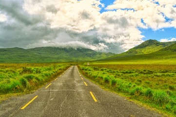 This is the road to the mountain on the Ballaghisheen pass in Co. Kerry on the west coast of Ireland. This is an amazing road to drive with amazing rolling fields all round. 