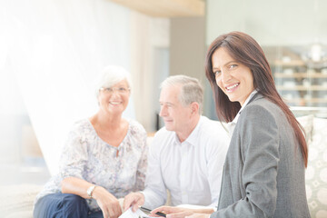 Financial advisor smiling with couple on sofa