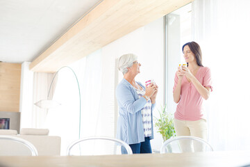 Mother and daughter having cup of coffee