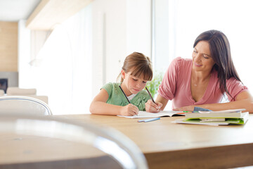 Mother helping daughter with homework